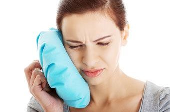 woman with pain due to tooth sensitivity