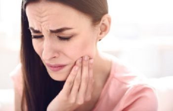 woman suffering from severe dental pain