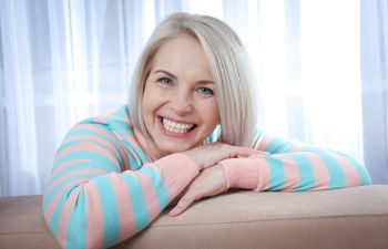 broadly smiling middle-aged woman