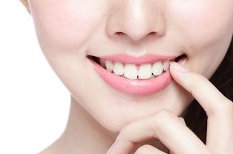 young woman pointing at her tooth