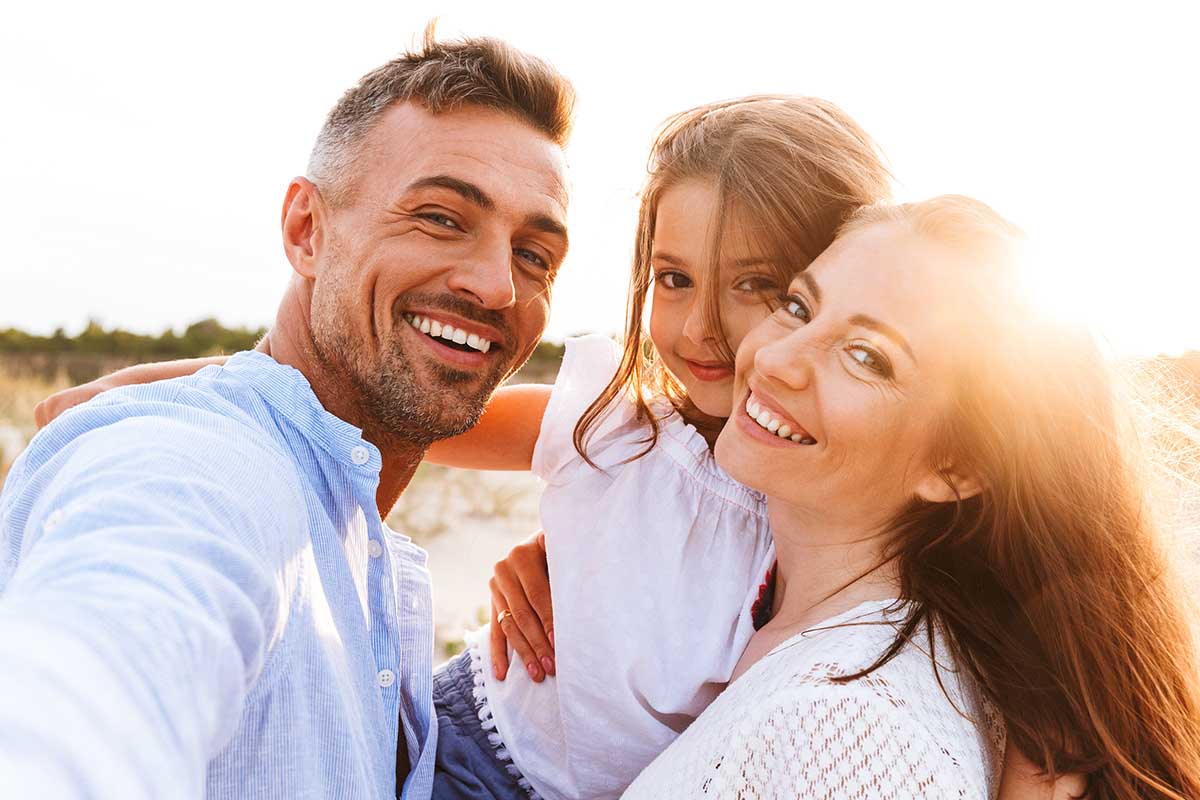 happy parents with their little daughter spending time outdoors