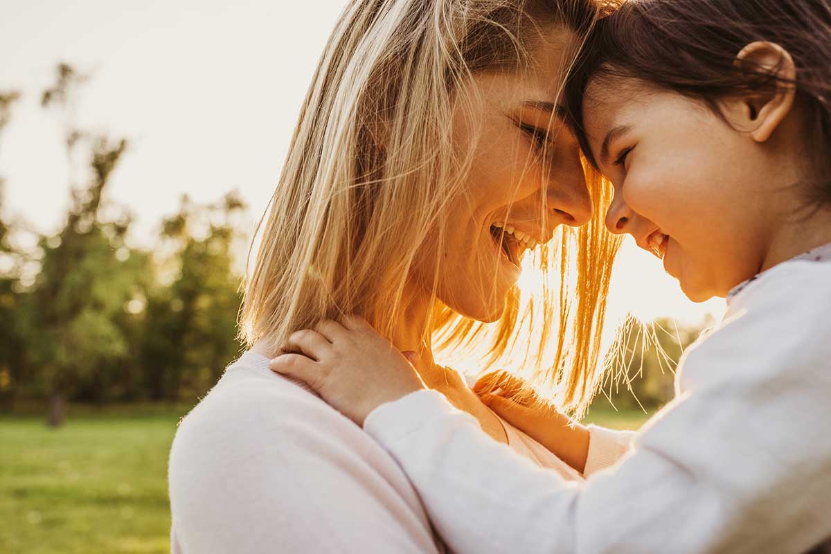 happy mother playing with her child in a park