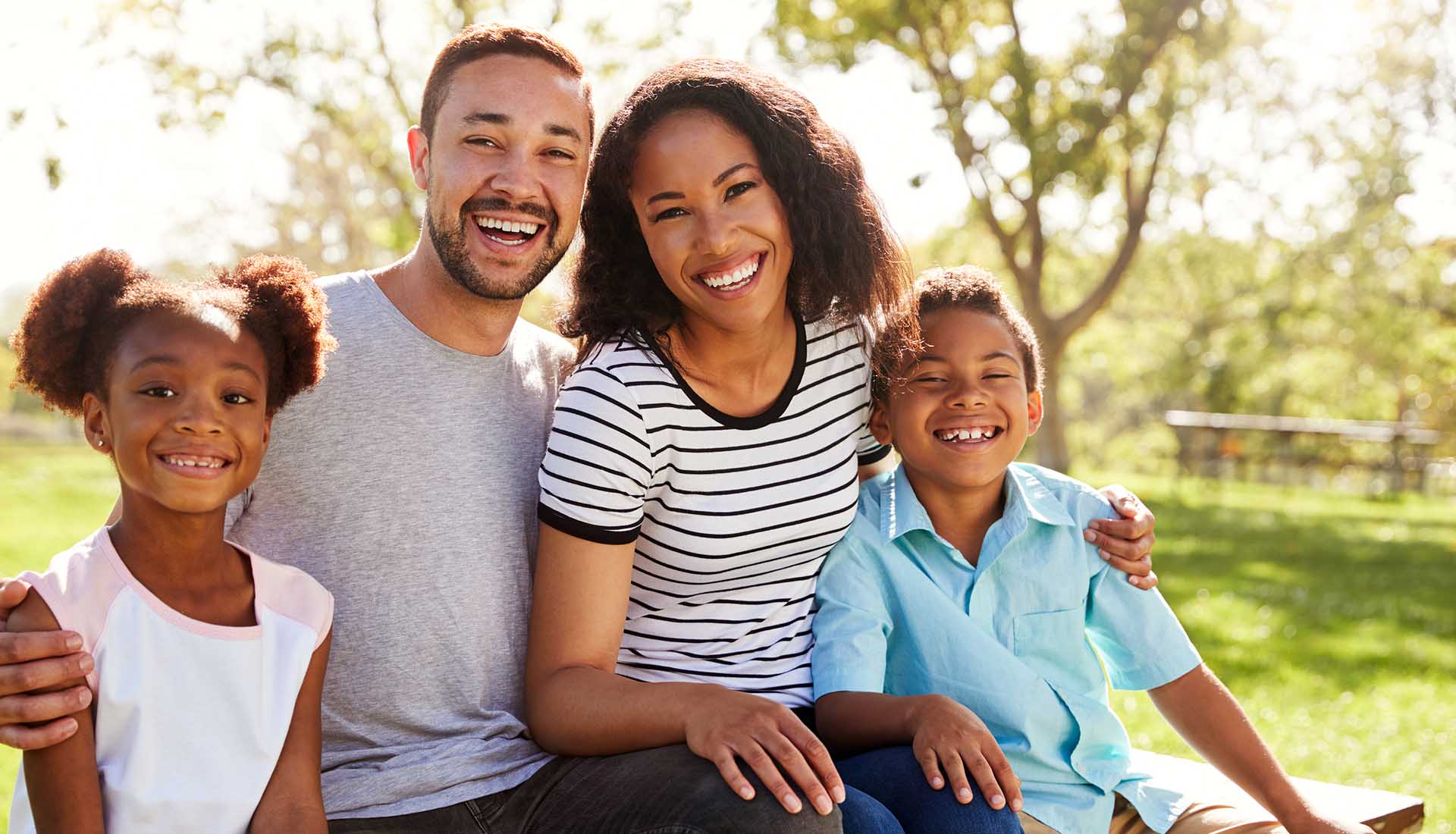 happy Afro-American family of four spending time outdoors