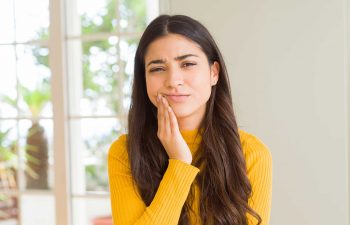 young woman suffering from dental pain