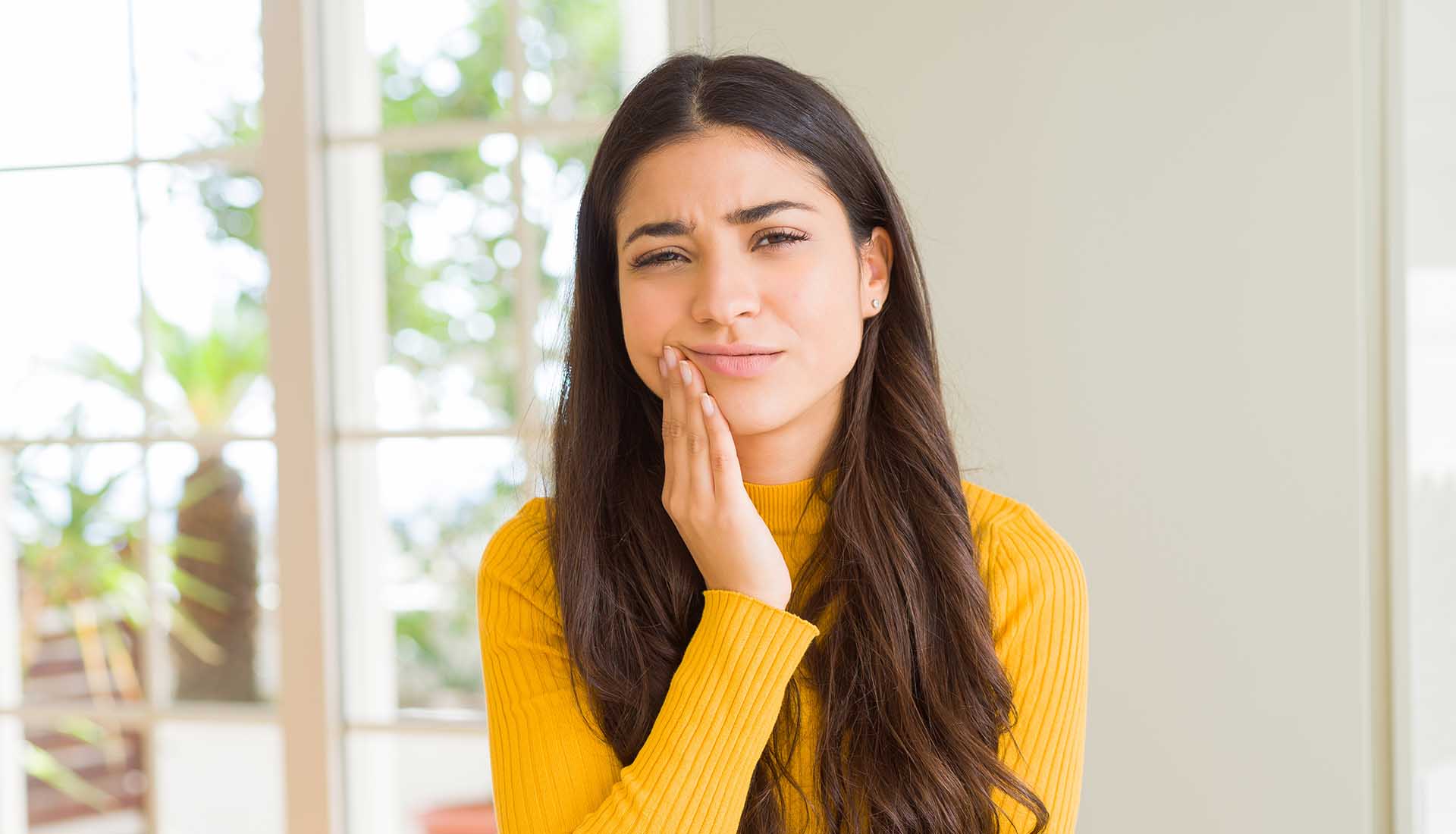 young woman suffering from dental pain