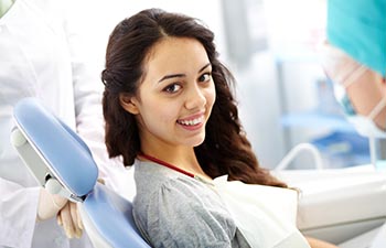 Young woman sitting in a dental chair.